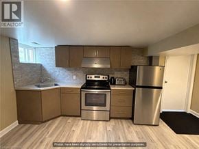 Hamilton apartment for rent - A kitchen with wooden floors and stainless steel appliances.