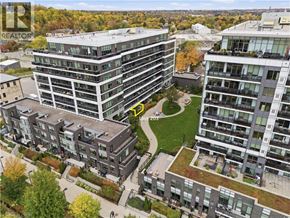 Guelph condo for rent - A bird's eye view of a residential area with apartment buildings and a green space in the middle.
