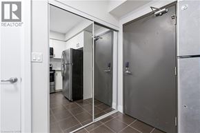 Guelph condo for rent - A white door is open to a kitchen.