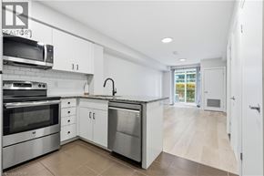 Guelph condo for rent - A modern kitchen with stainless steel appliances and white cabinets.