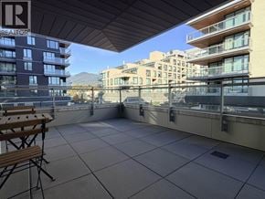 North Vancouver apartment for rent - A balcony with a table and chairs overlooking a cityscape.