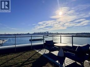 North Vancouver apartment for rent - A sunny day at the waterfront with a city skyline in the distance.