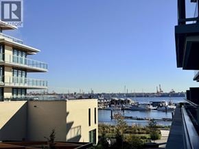 North Vancouver apartment for rent - A view of a harbor with boats and buildings in the background.