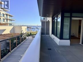 North Vancouver apartment for rent - A balcony with a view of the water and buildings.