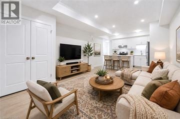 Kitchener townhouse for rent - A living room with a wooden floor and furniture.
