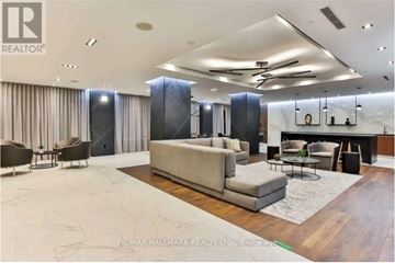 Toronto (Agincourt South-Malvern West) condo for rent - A spacious living room with a large couch and a dining table.