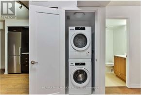 Toronto (Agincourt South-Malvern West) condo for rent - A white door with a washing machine and dryer in a small room.