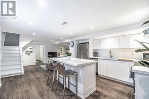 Toronto (Clairlea-Birchmount) apartment for rent - A well-lit kitchen with a dining table and chairs.