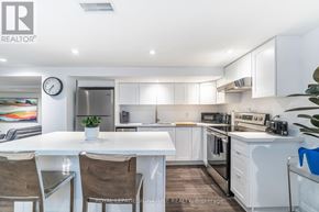 Toronto (Clairlea-Birchmount) apartment for rent - A white kitchen with a table and chairs.