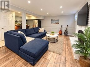 Toronto (Centennial Scarborough) apartment for rent - A living room with a blue couch and a guitar on the wall.