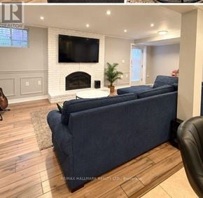 Toronto (Centennial Scarborough) apartment for rent - A living room with a blue couch and a fireplace.