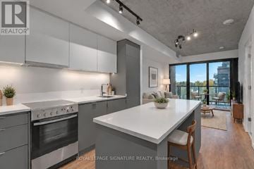Toronto (Stonegate-Queensway) condo for rent - A modern kitchen with a large island and stainless steel appliances.