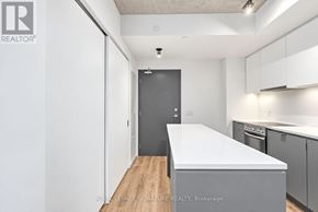 Toronto (Stonegate-Queensway) condo for rent - A white kitchen with a large island in the middle.