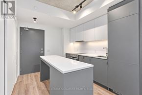 Toronto (Stonegate-Queensway) condo for rent - A modern kitchen with a white countertop and grey cabinets.