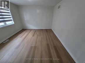 Brampton (Bram East) apartment for rent - A room with wooden flooring and a window.
