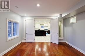 Milton (Cl Clarke) apartment for rent - A room with wooden floors and white walls, with a doorway leading to another room.