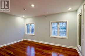 Milton (Cl Clarke) apartment for rent - A room with wooden floors and two windows.