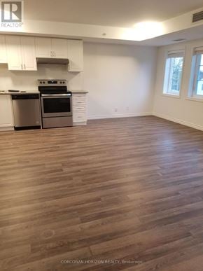 Tillsonburg house for rent - A kitchen with white cabinets and a stainless steel dishwasher.