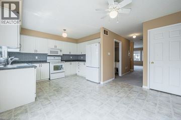 Kitchener townhouse for rent - A kitchen with white cabinets and a tile floor.