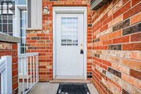 Kitchener townhouse for rent - A white door is on the right side of a brick wall.