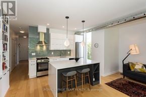 Ottawa condo for rent - A kitchen with white cabinets and a black island.