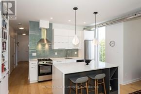 Ottawa condo for rent - A modern kitchen with white cabinets and a large island.