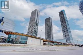 Vaughan (Vaughan Corporate Centre) condo for rent - A modern building with a glass facade stands in front of a construction site.