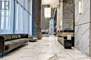 Vaughan (Vaughan Corporate Centre) condo for rent - A marble hallway with a bench and a reception desk.