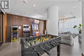 Vaughan (Vaughan Corporate Centre) condo for rent - A foosball table is in the middle of a room with a couch and a plant.