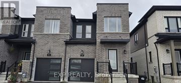Barrie (Painswick South) townhouse for rent - A row of houses with the first one having a sign that says EXP REALTY on it.