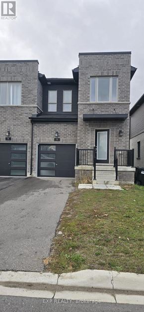 Barrie (Painswick South) townhouse for rent - A grey house with a black door and windows.