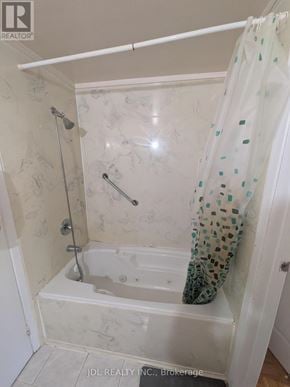 Toronto (L'amoreaux) townhouse for rent - A white bathroom with a shower curtain and a shower head.