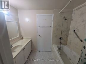 Toronto (L'amoreaux) townhouse for rent - A bathroom with a white door and a shower with a glass door.