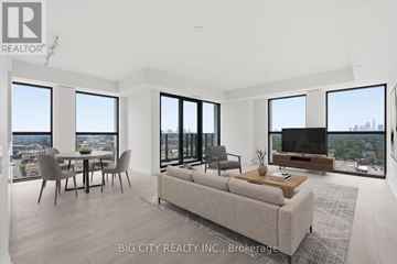 Toronto (Thorncliffe Park) condo for rent - A modern living room with a large couch and a television.
