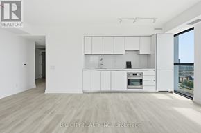 Toronto (Thorncliffe Park) condo for rent - A white kitchen with a view of the city.