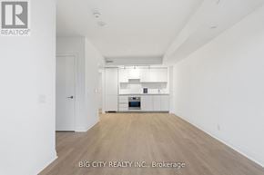 Toronto (Thorncliffe Park) condo for rent - A spacious room with a kitchen area in the middle.
