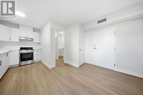 St. Catharines (Downtown) multi-family for rent - A spacious kitchen with white cabinets and a stainless steel oven.