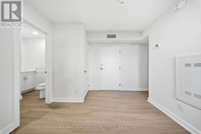 St. Catharines (Downtown) multi-family for rent - A white room with wood flooring and a doorway leading to another room.