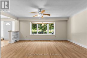 Toronto (Ionview) apartment for rent - A room with a ceiling fan and a window showing greenery outside.