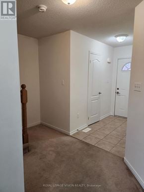 Innisfil (Alcona) townhouse for rent - A room with white walls and a carpeted floor.