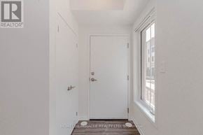 Vaughan (Vaughan Corporate Centre) townhouse for rent - A white door is in the middle of a hallway.
