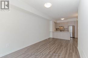 Vaughan (Vaughan Corporate Centre) townhouse for rent - A spacious room with a kitchenette in the background.