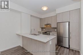 Vaughan (Vaughan Corporate Centre) townhouse for rent - A kitchen with a sink, stove and refrigerator.