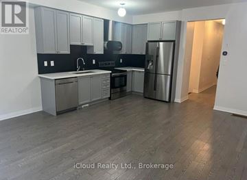 Clarington (Bowmanville) apartment for rent - A kitchen with a refrigerator, sink, and cabinets.