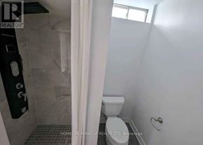 Vaughan (Vellore Village) apartment for rent - A bathroom with a toilet, a shower with a glass door, and a tiled floor.