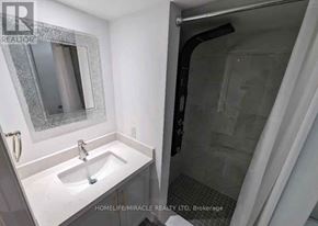 Vaughan (Vellore Village) apartment for rent - A bathroom with a sink, mirror, and shower.