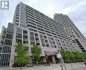 Toronto (Niagara) condo for rent - A tall residential building with a sign that reads "REALTOR" on the top left corner.