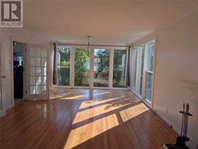 St. John's apartment for rent - A sunny room with wooden floors and sliding glass doors.