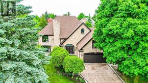 Richmond Hill (South Richvale) apartment for rent - A large house with a driveway and trees surrounding it.