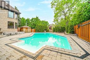 Richmond Hill (South Richvale) apartment for rent - A rectangular pool with a rounded corner and a brown fence.